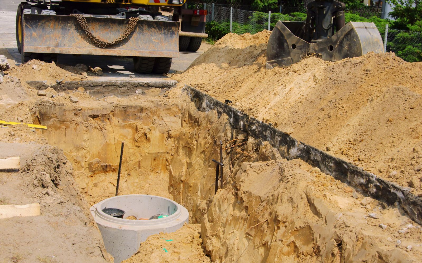 Deep excavation work forming a pond or pool area on a property
