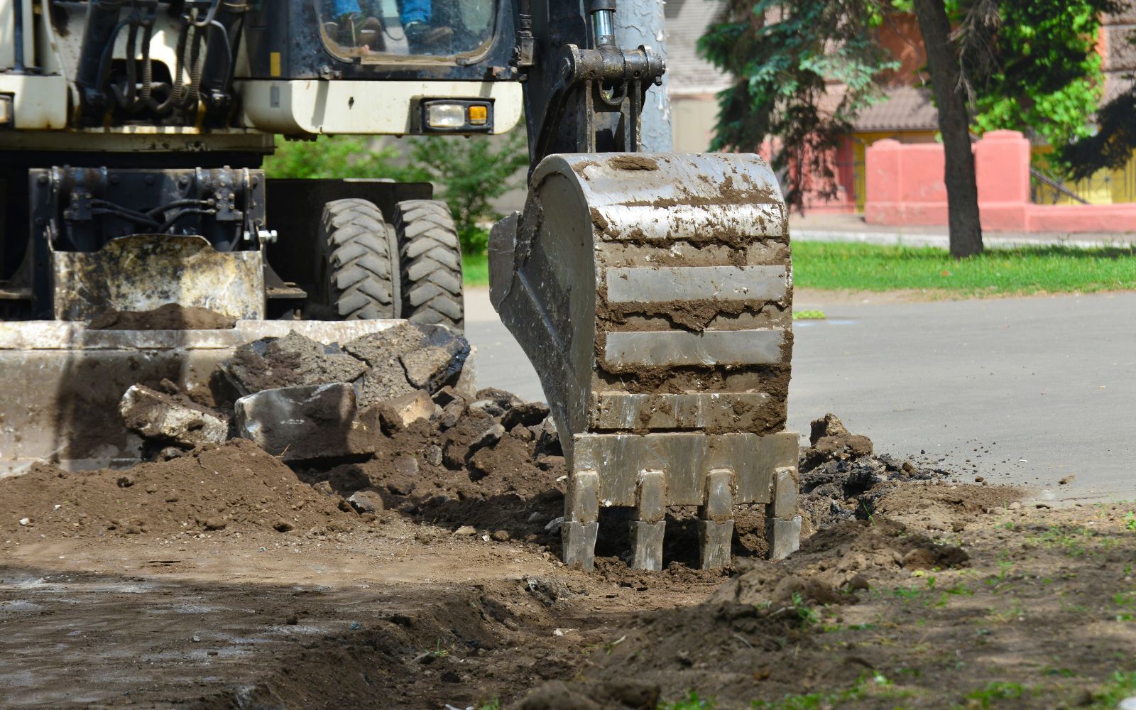 Excavator digging ground for site preparation and earthmoving work.