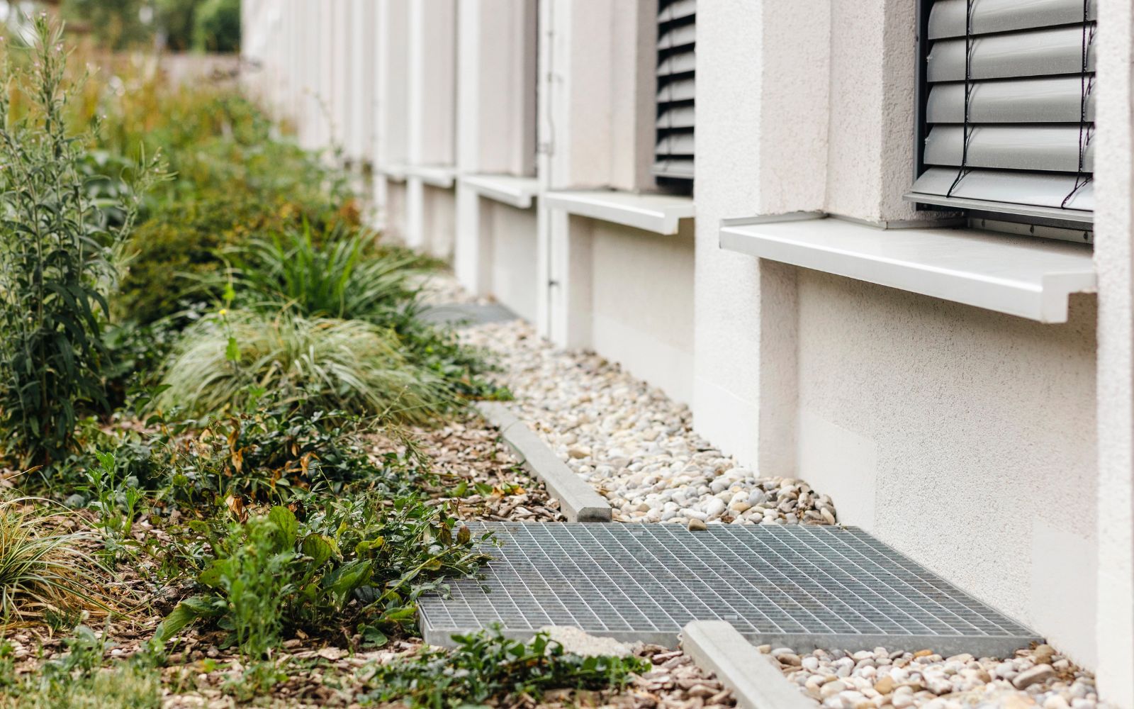 Installed French drainage trench with gravel for effective water redirection on residential property