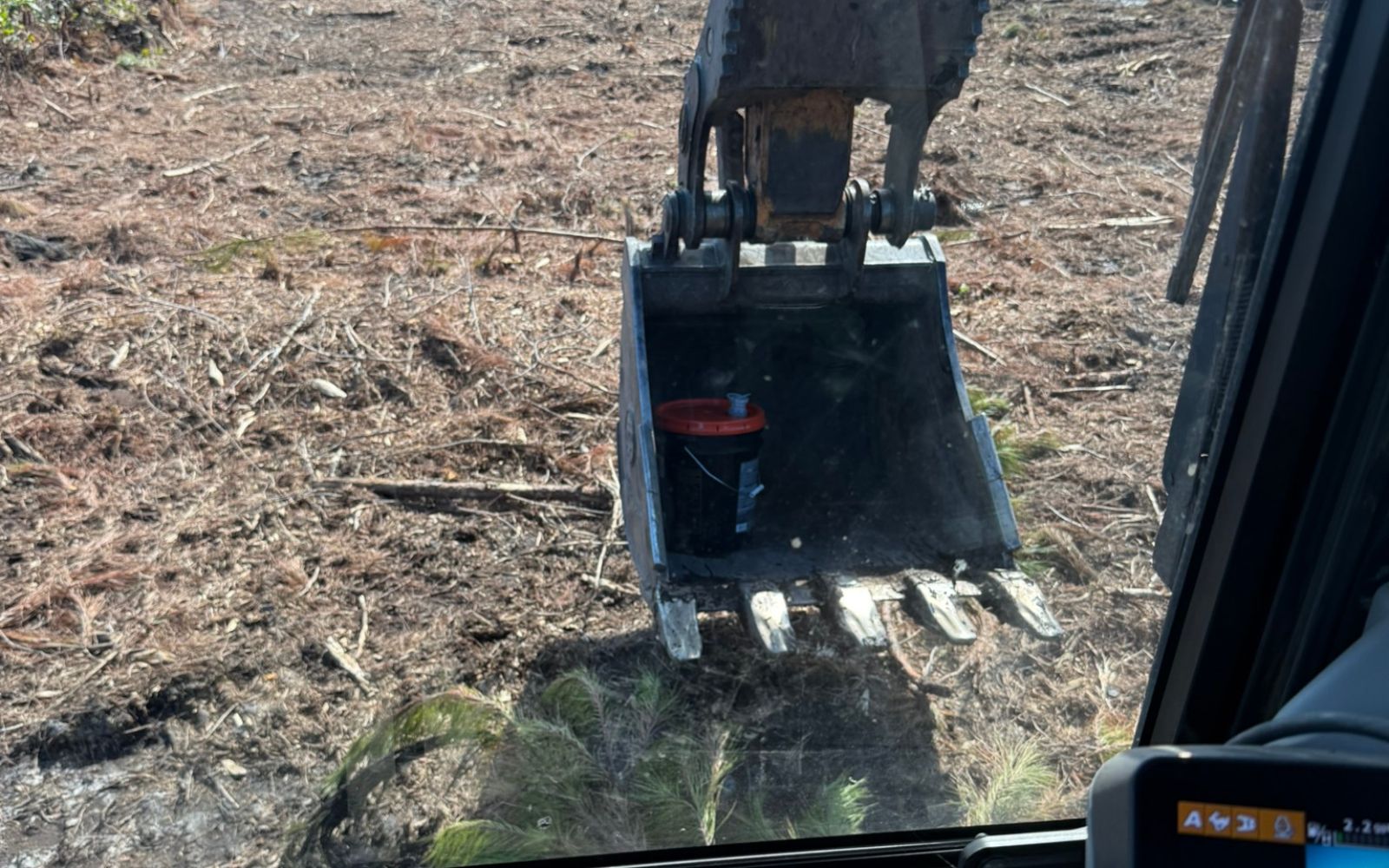 construction vehicle cab showing an excavator bucket