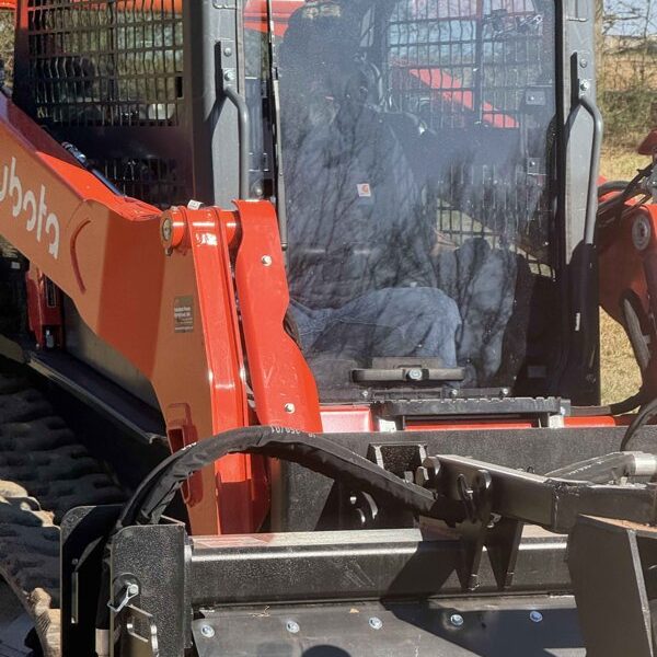 Experienced operator from Ground Truth Land Pros performing precision grading for a driveway restoration project